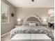 Cozy bedroom features a tufted headboard, soft lighting, and an adjacent bathroom at 1078 W Redwood Ave, Queen Creek, AZ 85140