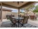 A covered patio area with a dining table and furniture sitting on a blue rug at 1078 W Redwood Ave, Queen Creek, AZ 85140