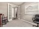 A carpeted home office area with french doors, neutral walls and natural light at 1078 W Redwood Ave, Queen Creek, AZ 85140