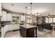 Bright, open kitchen featuring stainless appliances, a dining area, and seamless flow to the living room at 1078 W Redwood Ave, Queen Creek, AZ 85140