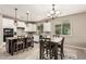 Bright kitchen with an island, tile backsplash, and an adjacent dining area and large window at 1078 W Redwood Ave, Queen Creek, AZ 85140