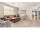 Comfortable living room with natural light, ceiling fan and two chairs at 1078 W Redwood Ave, Queen Creek, AZ 85140