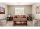 Cozy living room featuring a ceiling fan, end tables and sofa at 1078 W Redwood Ave, Queen Creek, AZ 85140