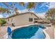 A sparkling blue pool and spa with waterfall feature are the focal point of the backyard at 1078 W Redwood Ave, Queen Creek, AZ 85140