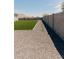 Nice backyard with artificial grass and rock bed next to block fence at 1244 N 106Th Pl, Mesa, AZ 85207