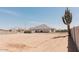 Large backyard behind block fence with desert landscaping and cactus at 1244 N 106Th Pl, Mesa, AZ 85207