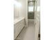 Bright bathroom features hexagon tile floor, double vanity, white cabinets, and a shower/tub combo with green tile at 1244 N 106Th Pl, Mesa, AZ 85207