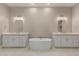 Bright bathroom showcasing dual vanities and a standalone tub perfect for relaxation at 1244 N 106Th Pl, Mesa, AZ 85207