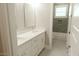 Bright bathroom features hexagon tile floor, double vanity, white cabinets, and a shower/tub combo at 1244 N 106Th Pl, Mesa, AZ 85207