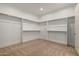 Spacious walk-in closet with built-in shelving and hanging rods, perfect for organization at 1244 N 106Th Pl, Mesa, AZ 85207