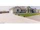 Spacious home with a long driveway and a manicured front yard providing a welcoming first impression at 1244 N 106Th Pl, Mesa, AZ 85207