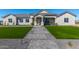 Beautiful single-story home with manicured lawn, gray stone pathway, and stylish exterior accents at 1244 N 106Th Pl, Mesa, AZ 85207