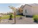 Charming single-story home with a stone-lined garden and lush trees enhancing the property's curb appeal at 1244 N 106Th Pl, Mesa, AZ 85207