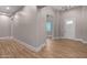Spacious foyer featuring wood-look tile flooring, neutral walls, and modern lighting at 1244 N 106Th Pl, Mesa, AZ 85207