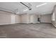 This is a large garage with painted floors and walls, and equipped with fluorescent lighting at 1244 N 106Th Pl, Mesa, AZ 85207