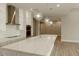 Modern kitchen features white cabinets, stainless steel appliances, pendant lighting, and quartz countertops at 1244 N 106Th Pl, Mesa, AZ 85207