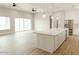 Open-concept kitchen and living area featuring a large island, stainless steel appliances, and abundant natural light at 1244 N 106Th Pl, Mesa, AZ 85207