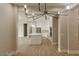 Open floor plan reveals a modern kitchen with white cabinets and quartz countertops at 1244 N 106Th Pl, Mesa, AZ 85207
