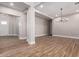 Large living space with modern lighting, neutral walls, and wood-look tile flooring at 1244 N 106Th Pl, Mesa, AZ 85207