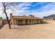 Rear view of home highlighting the covered patio, spacious yard and solar panels at 1403 W Wood Dr, Phoenix, AZ 85029
