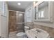 Bathroom featuring tiled walk-in shower, recessed shelving, and modern vanity at 1403 W Wood Dr, Phoenix, AZ 85029