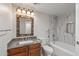 Well-lit bathroom featuring a tub/shower combo and ornate vanity at 1403 W Wood Dr, Phoenix, AZ 85029