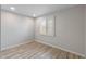 Cozy bedroom with shuttered window offering natural light and wood-look flooring at 1403 W Wood Dr, Phoenix, AZ 85029