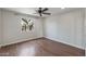 This bedroom has dark wood floors, ceiling fan and a window offering great light at 1403 W Wood Dr, Phoenix, AZ 85029