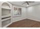 Bedroom featuring wood floors, ceiling fan, recessed lights, a window with shutters, and built-in shelves at 1403 W Wood Dr, Phoenix, AZ 85029