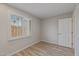 Comfortable bedroom with shuttered window offering natural light and wood-look flooring at 1403 W Wood Dr, Phoenix, AZ 85029