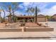 Charming single-story home featuring desert landscaping, a two-car garage, and a covered front porch at 1403 W Wood Dr, Phoenix, AZ 85029