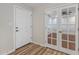 Hallway with wood floors, a front door, a closet door, and glass french doors to another room at 1403 W Wood Dr, Phoenix, AZ 85029