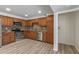 The open kitchen features stainless appliances, warm wood cabinets and floors at 1403 W Wood Dr, Phoenix, AZ 85029