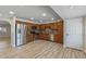 Updated kitchen shows new stainless appliances, wood cabinetry, and light wood floors at 1403 W Wood Dr, Phoenix, AZ 85029