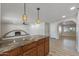 Gourmet kitchen with granite counters, wood cabinets, and a breakfast bar at 1403 W Wood Dr, Phoenix, AZ 85029