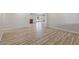 Spacious open-concept living room featuring wood floors, neutral walls, and an arched entry to other rooms at 1403 W Wood Dr, Phoenix, AZ 85029