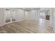 Bright living room with wood floors and neutral walls plus a view of another room with built-ins at 1403 W Wood Dr, Phoenix, AZ 85029