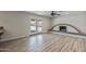 Open-concept living room featuring wood floors, fireplace, and glass doors to the backyard at 1403 W Wood Dr, Phoenix, AZ 85029