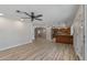 A spacious living room includes wood flooring and a view into the kitchen at 1403 W Wood Dr, Phoenix, AZ 85029