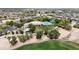 Aerial view of community center clubhouse, pool, green spaces and parking at 14390 W Desert Flower Dr, Goodyear, AZ 85395