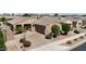 Aerial view showcases the property's charming desert landscaping, brick driveway, and well-maintained surroundings at 14390 W Desert Flower Dr, Goodyear, AZ 85395