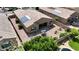 Aerial view showcases a backyard with desert landscaping and a cozy patio with a swing, plus a pool nearby at 14390 W Desert Flower Dr, Goodyear, AZ 85395