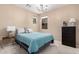 Bright bedroom featuring soft carpet, lots of natural light, and neutral wall paint at 14390 W Desert Flower Dr, Goodyear, AZ 85395