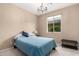 Cozy bedroom featuring soft carpet, neutral paint, and a sunny window that offers abundant natural light at 14390 W Desert Flower Dr, Goodyear, AZ 85395