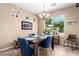 Cozy dining area with natural light from a window overlooking the yard at 14390 W Desert Flower Dr, Goodyear, AZ 85395