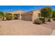 Charming single-story home featuring desert landscaping, a brick driveway, and an attached two-car garage at 14390 W Desert Flower Dr, Goodyear, AZ 85395