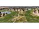 Aerial view of the golf course featuring ponds, green grass, and winding paths at 14390 W Desert Flower Dr, Goodyear, AZ 85395