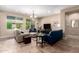 Bright living room with large windows, comfortable seating, and stylish decor, creating an inviting space at 14390 W Desert Flower Dr, Goodyear, AZ 85395