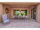Cozy covered patio with paver flooring and comfortable seating, perfect for relaxing and entertaining outdoors at 14390 W Desert Flower Dr, Goodyear, AZ 85395