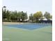 Community tennis courts with green and blue surfaces and metal fencing at 14390 W Desert Flower Dr, Goodyear, AZ 85395